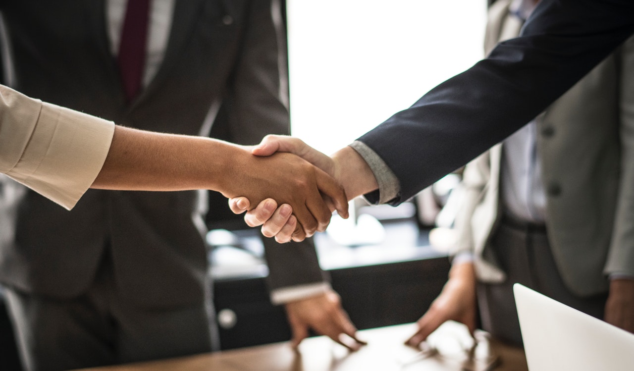 Executive handshake at a MIBI business gathering